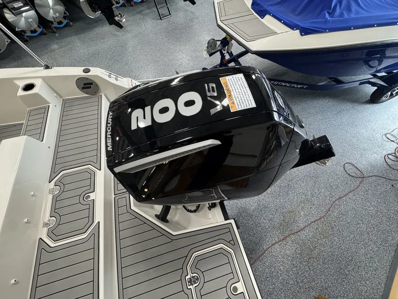 Slide: The Image of Starcraft 211SVXOB from 2027 with a 200 HP outboard motor, gray deck, and blue cover. - 8