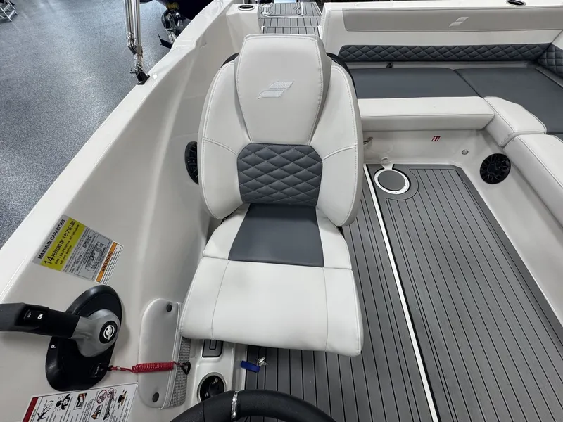 Slide: The Image of The image shows the interior of a Starcraft 211SVXOB boat with a cushioned seat and gray flooring. - 14