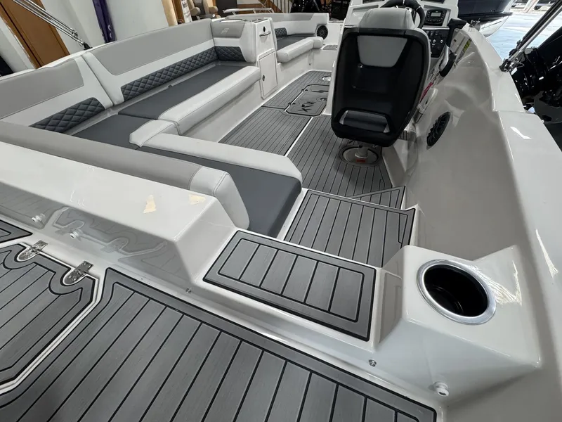 Slide: The Image of The image shows the interior of a 2027 Starcraft 211SVXOB boat with gray upholstery and flooring. - 9