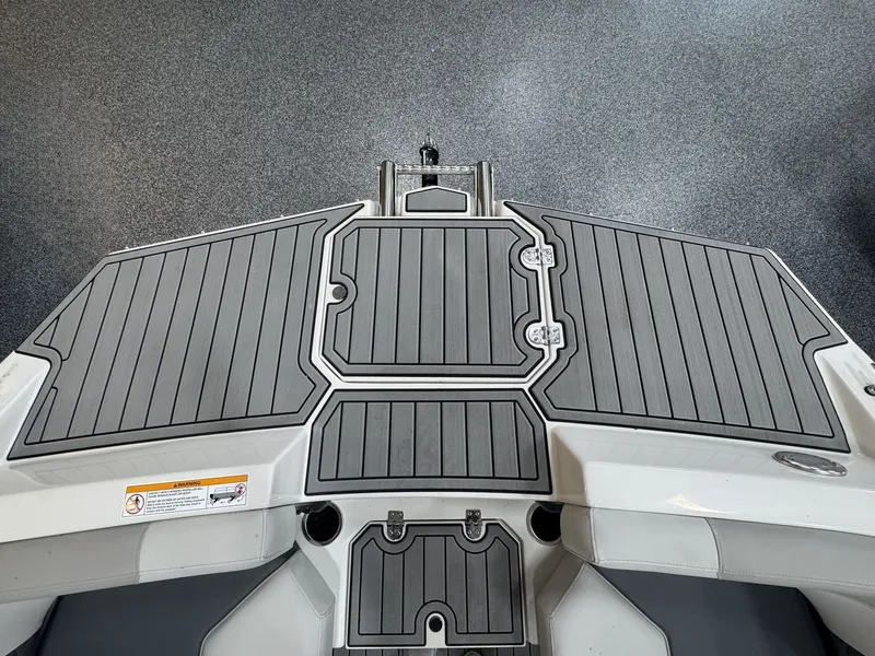 Slide: The Image of Rear view of a boat with gray textured deck and two cup holders. - 35