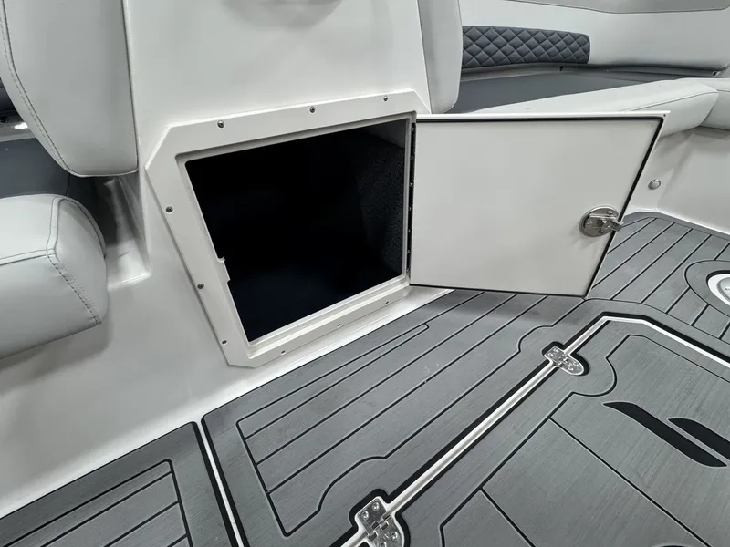 Slide: The Image of Open storage compartment in a modern boat with gray flooring and cushioned seating. - 24