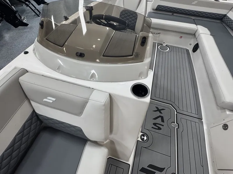 Slide: The Image of The image shows the cockpit of a Starcraft 211SVXOB boat with gray upholstery and a modern helm. - 29