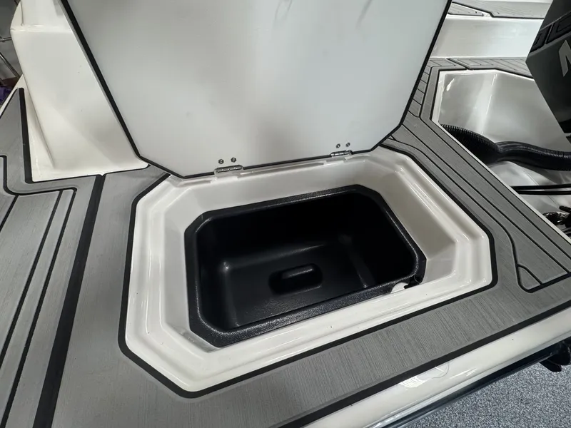 Slide: The Image of The image shows a storage compartment on a 2027 Starcraft 211SVXOB boat. - 3
