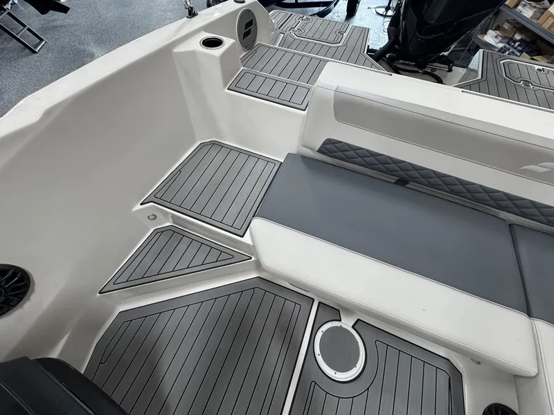Slide: The Image of The image shows the interior of a Starcraft 211SVXOB boat with gray upholstery and flooring. - 10