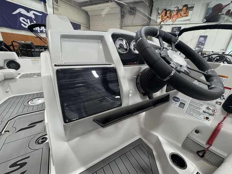 Slide: The Image of The image shows the helm of a 2027 Starcraft 211SVXOB boat. - 15
