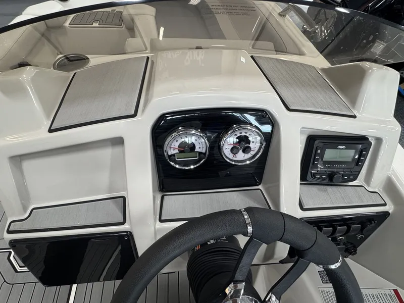 Slide: The Image of The dashboard of a 2027 Starcraft 211SVXOB with modern gauges and controls. - 16