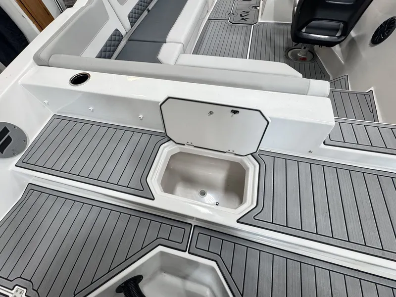 Slide: The Image of The image shows the deck of a 2027 Starcraft 211SVXOB with gray flooring and seating area. - 7