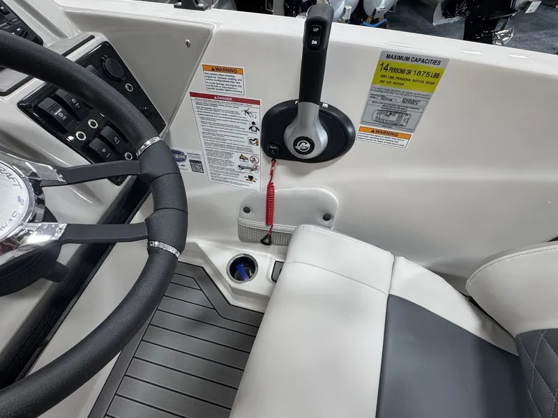Slide: The Image of The image shows the cockpit of a Starcraft 211SVXOB boat with steering wheel, throttle, and safety labels. - 19