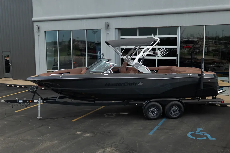 Slide: The Image of 2020 MasterCraft XT25 boat on trailer outside dealership. - 4