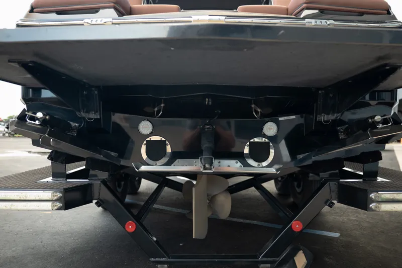 Slide: The Image of Rear view of a 2020 MasterCraft XT25 boat on a trailer, showcasing its propeller and hull design. - 9