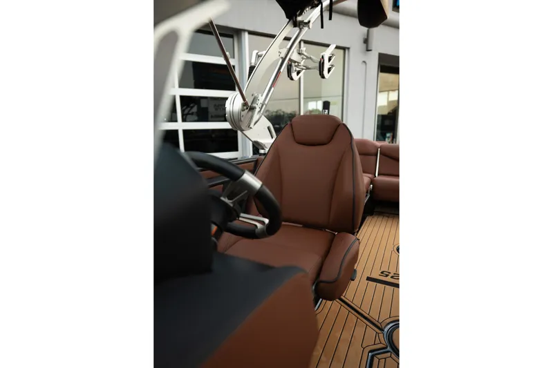 Slide: The Image of 2020 MasterCraft XT25 interior with brown leather seats and modern steering wheel. - 19