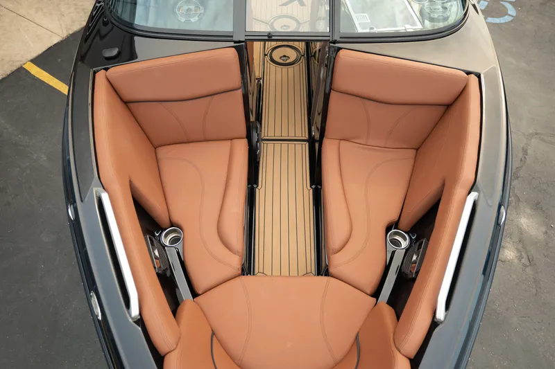 Slide: The Image of 2020 MasterCraft XT25 boat interior with tan leather seating and sleek design. - 14