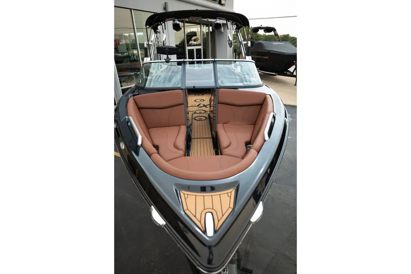 Slide: The Image of 2020 MasterCraft XT25 boat with luxurious brown seating and sleek design. - 13
