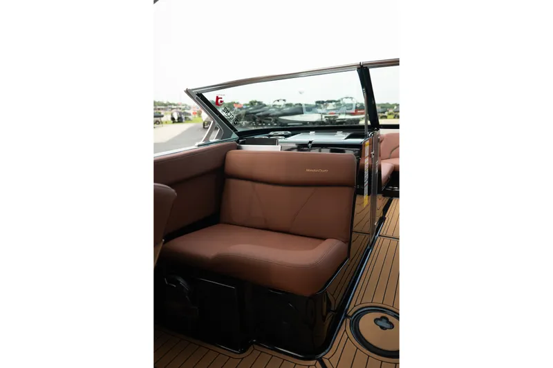 Slide: The Image of 2020 MasterCraft XT25 boat interior with brown seating and sleek design. - 26