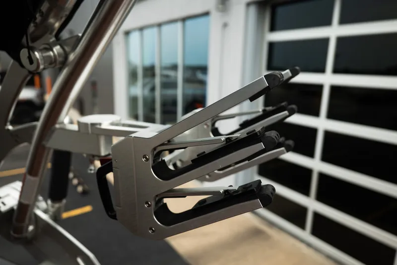 Slide: The Image of Close-up of a 2020 MasterCraft XT25 boat's wakeboard rack in a garage setting. - 34