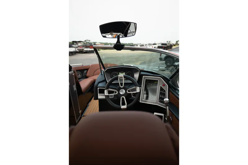 Slide: The Image of Interior view of 2020 MasterCraft XT25 boat cockpit with modern steering and controls. - 25
