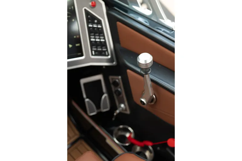 Slide: The Image of Interior of 2020 MasterCraft XT25 boat showing control panel and throttle lever. - 23