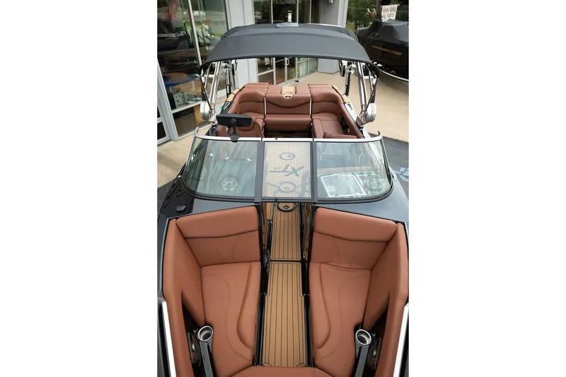 Slide: The Image of 2020 MasterCraft XT25 boat interior with brown leather seats and sleek design. - 15