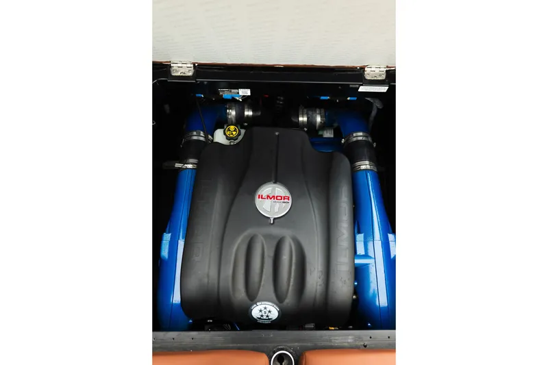 Slide: The Image of 2020 MasterCraft XT25 Ilmor engine with blue hoses in boat compartment. - 32