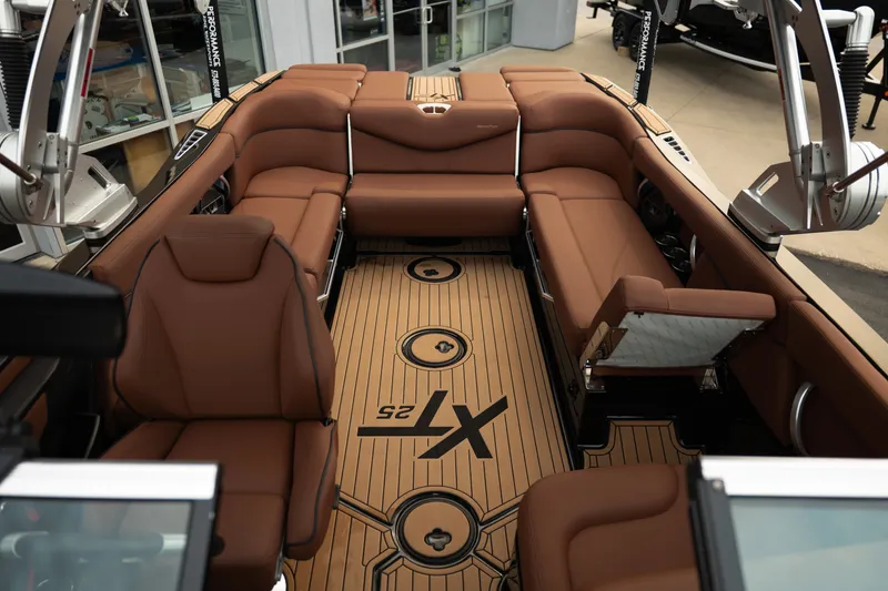 Slide: The Image of 2020 MasterCraft XT25 boat interior with brown seating and stylish flooring. - 20