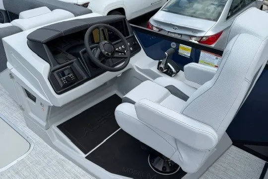 Slide: The Image of 2027 Alera M25Q boat cockpit with modern steering and controls, featuring a comfortable captain's chair. - 45