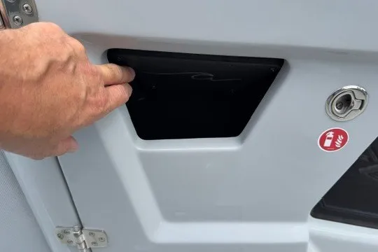 Slide: The Image of Hand accessing compartment on 2027 Alera M25Q vehicle door. - 47