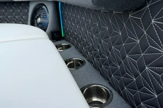 Slide: The Image of Luxurious interior of 2027 Alera M25Q with geometric stitching and cup holders. - 58