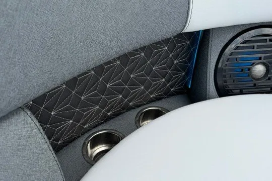 Slide: The Image of Interior of 2027 Alera M25Q featuring geometric upholstery, cup holders, and speaker. - 59