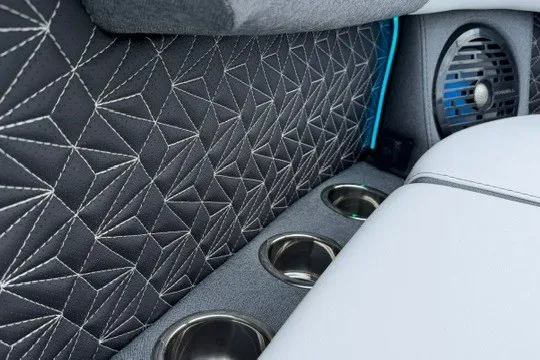 Slide: The Image of Luxurious interior of 2027 Alera M25Q with geometric stitching and cup holders. - 33