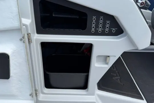 Slide: The Image of Control panel and storage compartment of 2027 Alera M25Q boat. - 48