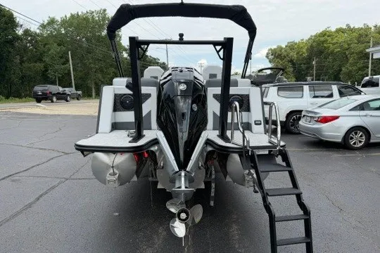 Slide: The Image of 2027 Alera M25Q boat with outboard motor and ladder, parked in a lot. - 14