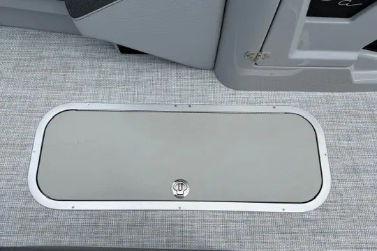 Slide: The Image of Alera M25Q 2027 boat storage compartment with secure latch on textured flooring. - 49