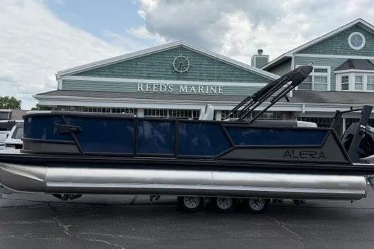Slide: The Image of Alera M25Q pontoon boat parked outside Reed's Marine, 2027 model. - 8