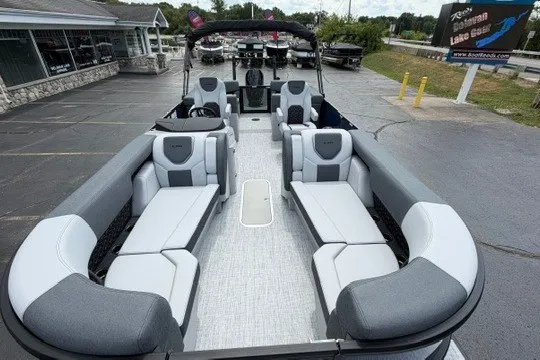 Slide: The Image of 2027 Alera M25Q pontoon boat with spacious seating and modern design in a parking lot. - 63