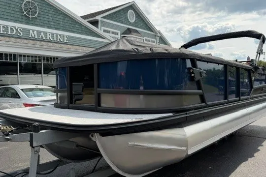 Slide: The Image of Alera M25Q pontoon boat, 2027 model, parked outside a marine store. - 86