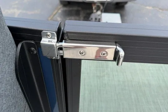 Slide: The Image of Stainless steel latch on Alera M25Q, 2027 model, securing a door frame. - 61