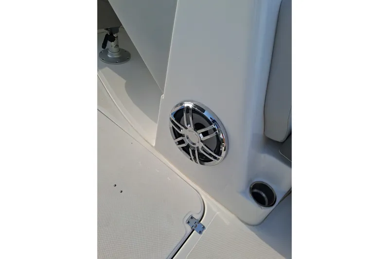 Slide: The Image of 2024 Hurricane SunDeck 191 OB boat interior with speaker and cup holder detail. - 10