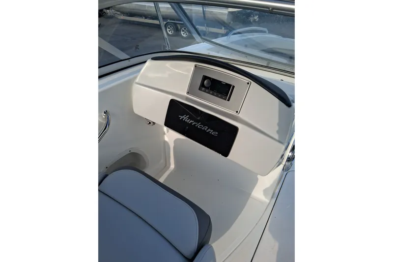 Slide: The Image of 2024 Hurricane SunDeck 191 OB boat interior with dashboard and seating. - 17
