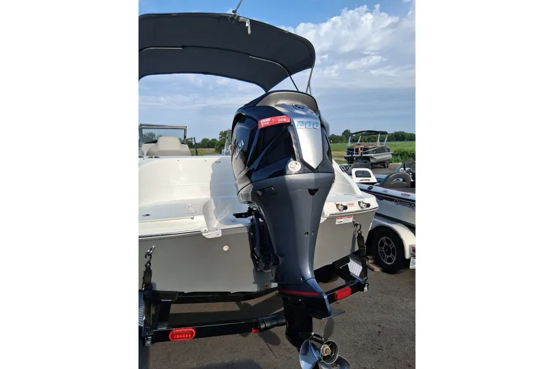 Slide: The Image of 2024 Hurricane SunDeck 191 OB boat with Yamaha outboard motor, parked outdoors. - 3