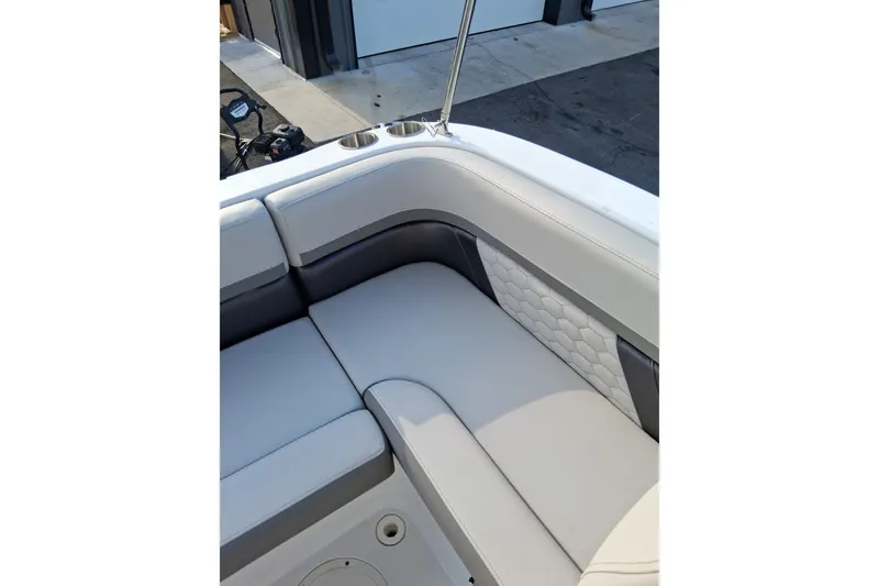 Slide: The Image of 2024 Hurricane SunDeck 191 OB boat interior with cushioned seating and cup holders. - 13