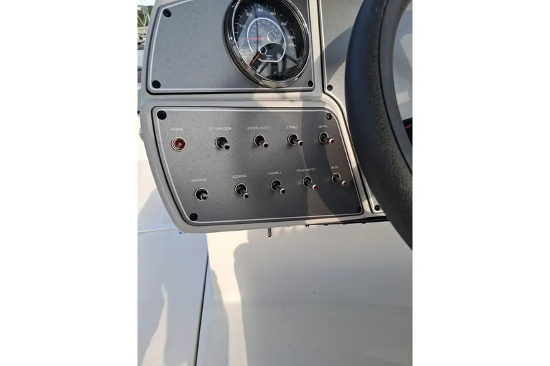 Slide: The Image of 2024 Hurricane SunDeck 191 OB dashboard with control switches and speedometer. - 15