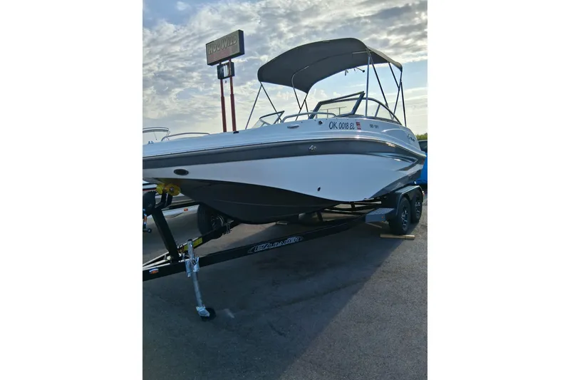 Slide: The Image of 2024 Hurricane SunDeck 191 OB boat on trailer under cloudy sky. - 6