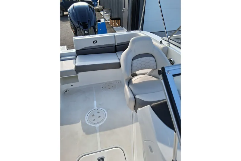 Slide: The Image of 2024 Hurricane SunDeck 191 OB boat interior with seating and outboard motor. - 11