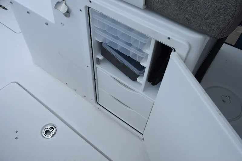 Slide: The Image of Storage compartment on a 2027 Sea Hunt Gamefish 28CB boat, featuring organized drawers and trays. - 24