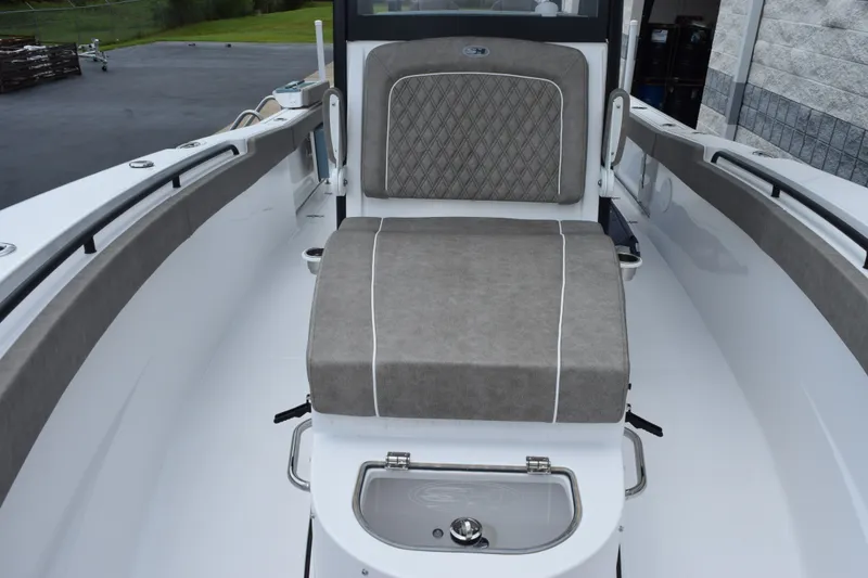 Slide: The Image of 2027 Sea Hunt Gamefish 28CB boat interior with cushioned seating and storage compartment. - 14