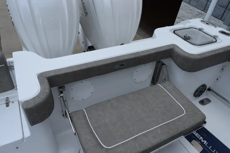 Slide: The Image of 2027 Sea Hunt Gamefish 28CB boat interior with cushioned seating and dual outboard motors. - 28