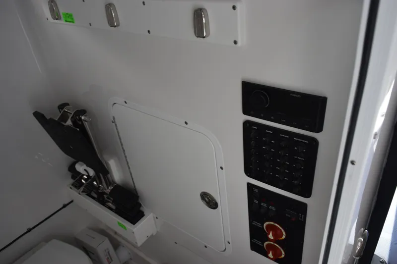 Slide: The Image of Interior controls of 2027 Sea Hunt Gamefish 28CB boat, featuring panel and storage. - 20