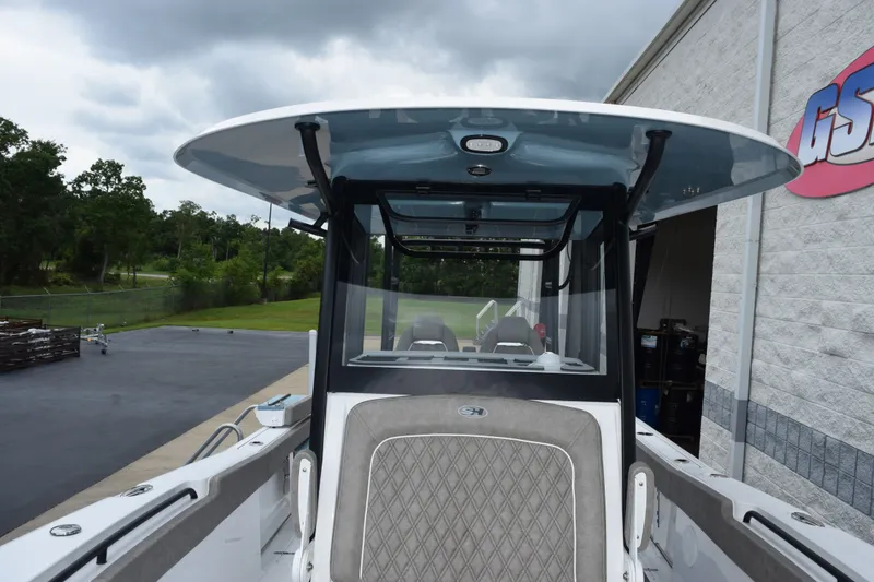 Slide: The Image of 2027 Sea Hunt Gamefish 28CB boat with sleek design, parked near a building. - 15