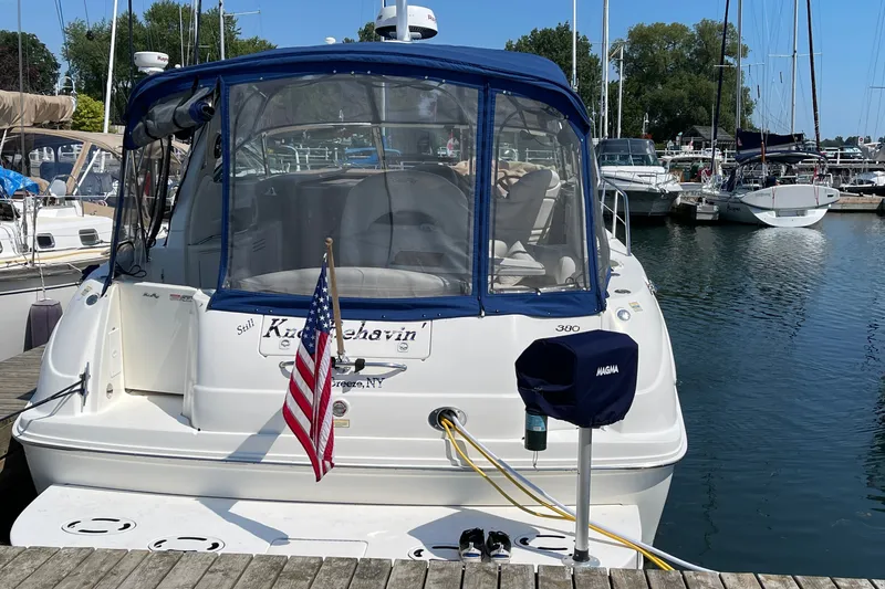 Slide: The Image of 2000 Sea Ray 380 Sundancer docked at marina with American flag. - 34