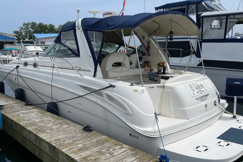 Slide: The Image of Sea Ray 380 Sundancer 2000 docked at marina, featuring sleek design and spacious deck. - 38